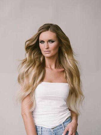 Beautiful woman long hair blonde natural portrait with beauty makeup. Studio shot.の写真素材