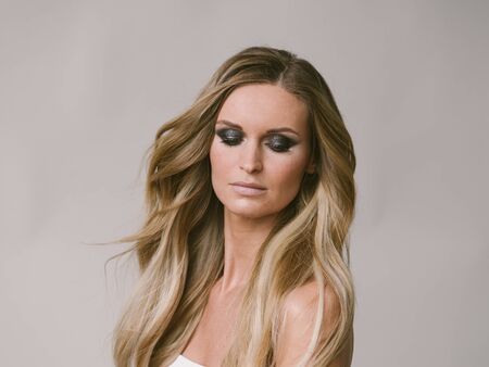 Beautiful woman long hair blonde natural portrait with beauty makeup. Studio shot.の写真素材