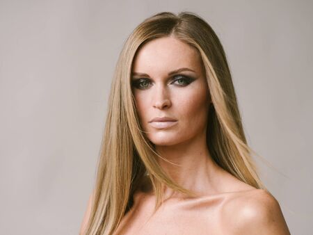 Beautiful woman long hair blonde natural portrait with beauty makeup. Studio shot.の写真素材