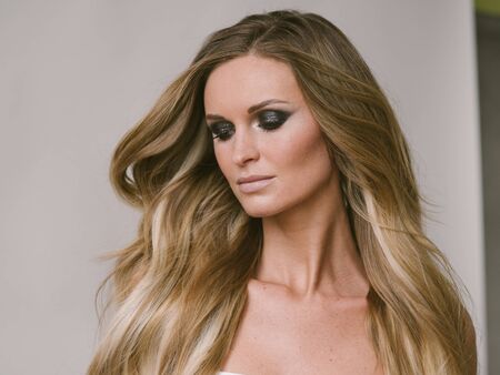 Beautiful woman long hair blonde natural portrait with beauty makeup. Studio shot.の写真素材