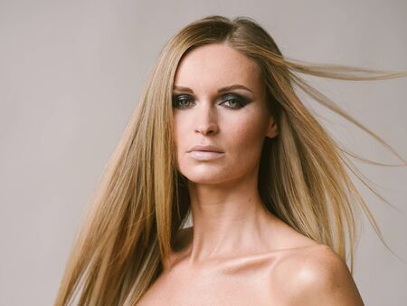 Beautiful woman long hair blonde natural portrait with beauty makeup. Studio shot.の写真素材