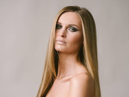 Beautiful woman long hair blonde natural portrait with beauty makeup. Studio shot.の写真素材