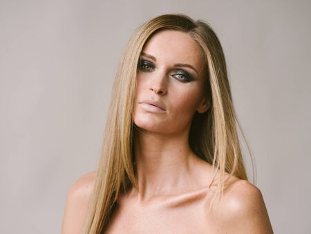 Beautiful woman long hair blonde natural portrait with beauty makeup. Studio shot.の写真素材