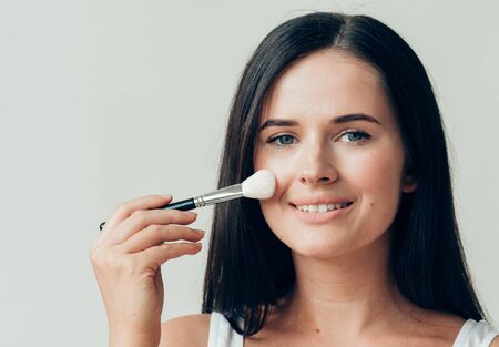 Brush  makeup woman face healthy skin natural make up powder. Studio shot.の写真素材