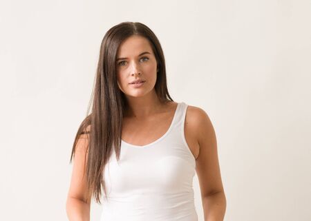 Natural brunette woman long hair casual makeup. Studio shot.の写真素材