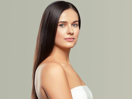 Beauty face woman young beautiful girl Gorgeous female portrait brown hair. Young adult girl with healthy skin fashion eye makeup. Studio shot.の写真素材
