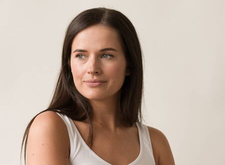 Natural brunette woman long hair casual makeup. Studio shot.の写真素材