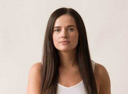 Natural brunette woman long hair casual makeup. Studio shot.の写真素材