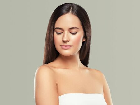 Beauty face woman young beautiful girl Gorgeous female portrait brown hair. Young adult girl with healthy skin fashion eye makeup. Studio shot.の写真素材