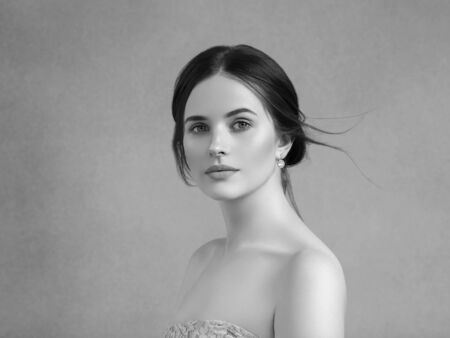 Beautiful woman portrait beauty hair and skin makeup young model. Studio shot. Monochrome. Gray. Black and white.の写真素材