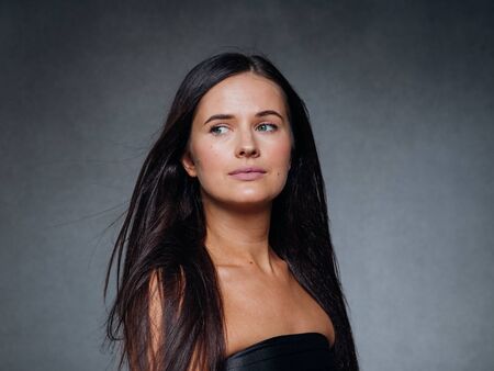 Beautiful woman art concept long brunette hair natural makeup fashion picture. Studio shot.の写真素材