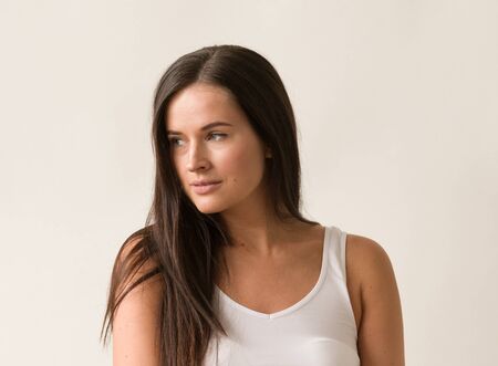 Natural brunette woman long hair casual makeup. Studio shot.の写真素材