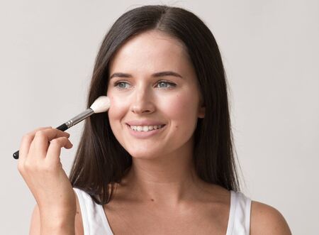 Brush  makeup woman face healthy skin natural make up powder. Studio shot.の写真素材