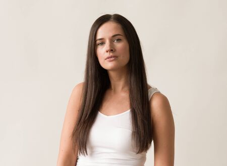 Natural brunette woman long hair casual makeup. Studio shot.の写真素材