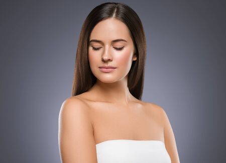 Beauty face woman young beautiful girl Gorgeous female portrait brown hair. Young adult girl with healthy skin fashion eye makeup. Studio shot.の写真素材