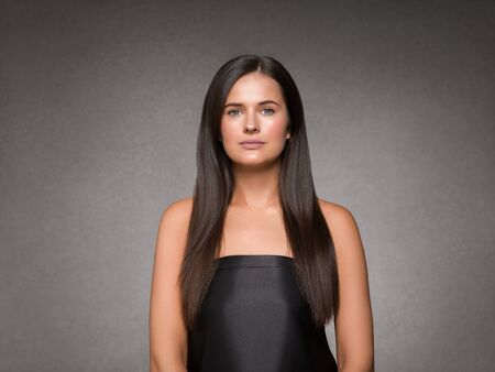 Beautiful woman art concept long brunette hair natural makeup fashion picture. Studio shot.の写真素材