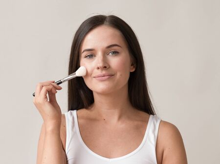 Brush  makeup woman face healthy skin natural make up powder. Studio shot.の写真素材