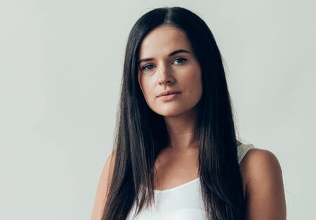 Natural brunette woman long hair casual makeup. Studio shot.の写真素材