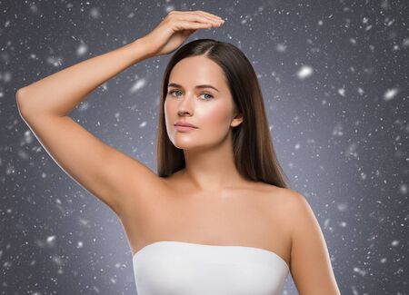 Winter armpit woman winter concept snowflakes background woman hand up beauty depilation. Studio shot.の写真素材