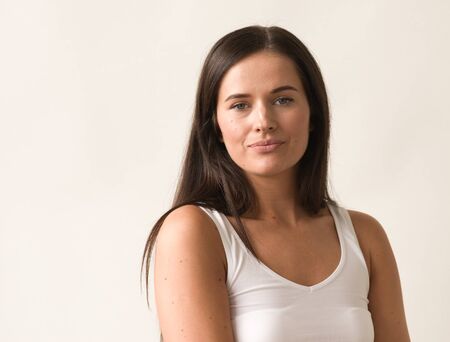 Natural brunette woman long hair casual makeup. Studio shot.の写真素材