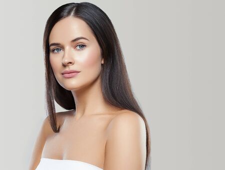 Beauty face woman young beautiful girl Gorgeous female portrait brown hair. Young adult girl with healthy skin fashion eye makeup. Studio shot.の写真素材