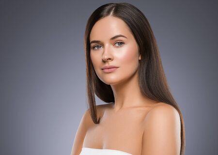 Beauty face woman young beautiful girl Gorgeous female portrait brown hair. Young adult girl with healthy skin fashion eye makeup. Studio shot.の写真素材
