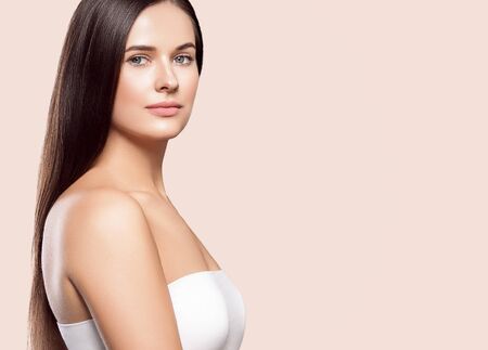 Beauty face woman young beautiful girl Gorgeous female portrait brown hair. Young adult girl with healthy skin fashion eye makeup. Studio shot.の写真素材