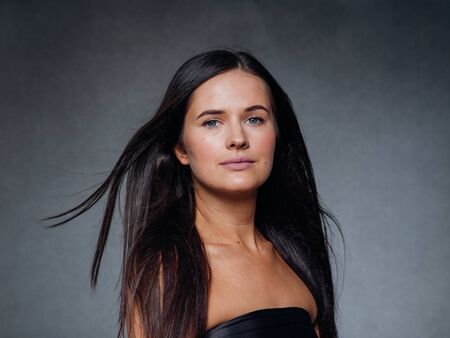 Beautiful woman art concept long brunette hair natural makeup fashion picture. Studio shot.の写真素材