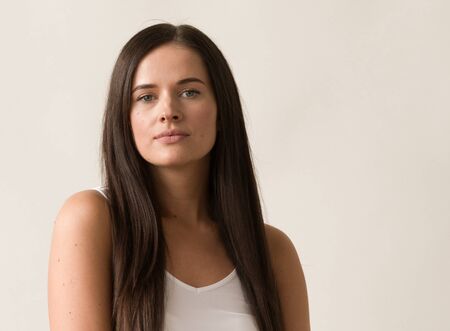 Natural brunette woman long hair casual makeup. Studio shot.の写真素材