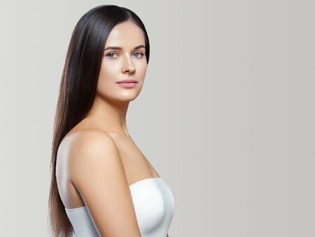 Beauty face woman young beautiful girl Gorgeous female portrait brown hair. Young adult girl with healthy skin fashion eye makeup. Studio shot.の写真素材