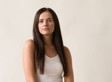 Natural brunette woman long hair casual makeup. Studio shot.の写真素材