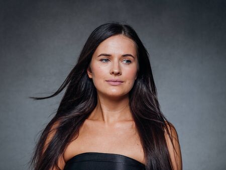 Beautiful woman art concept long brunette hair natural makeup fashion picture. Studio shot.の写真素材