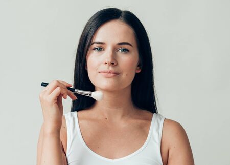 Brush  makeup woman face healthy skin natural make up powder. Studio shot.の写真素材