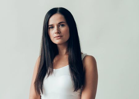 Natural brunette woman long hair casual makeup. Studio shot.の写真素材