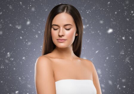 Beauty face woman young beautiful girl Gorgeous female portrait brown hair. Young adult girl with healthy skin fashion eye makeup. Studio shot.の写真素材
