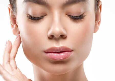 Asia beauty woman  with closed eyes healthy skin face clean fresh skin spa. Studio shot.  Isolated on white.の写真素材