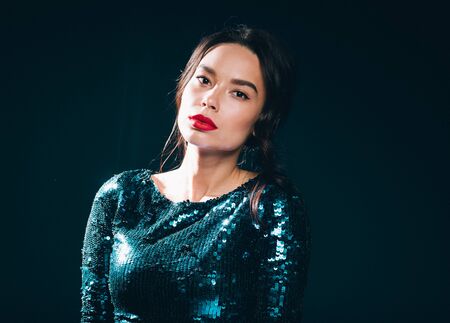 Woman in sequin dress night club concept red lips asian beauty. Studio shot.の写真素材
