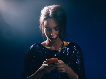 Woman in sequin dress night club concept red lips asian beauty. Studio shot.の写真素材