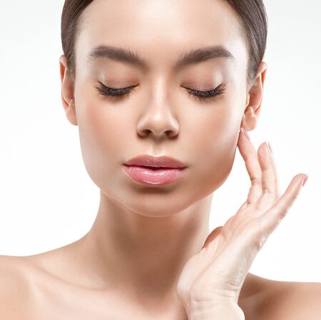 Asia beauty woman  with closed eyes healthy skin face clean fresh skin spa. Studio shot.  Isolated on white.の写真素材