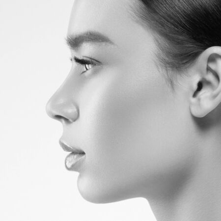 Asian beauty profile woman healthy skin natural makeup isolated on white cosmetic beautiful portrait. Studio shot. Monochrome. Gray. Black and white.の写真素材