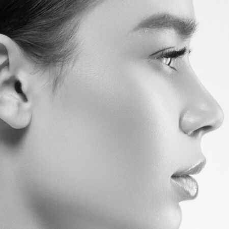 Asian beauty profile woman healthy skin natural makeup isolated on white cosmetic beautiful portrait. Studio shot. Monochrome. Gray. Black and white.の写真素材