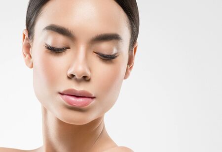 Asia beauty woman  with closed eyes healthy skin face clean fresh skin spa. Studio shot.  Isolated on white.の写真素材