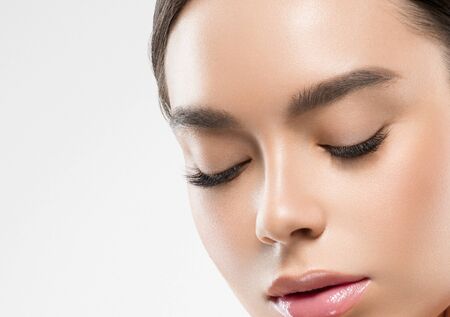 Asia beauty woman  with closed eyes healthy skin face clean fresh skin spa. Studio shot.  Isolated on white.の写真素材