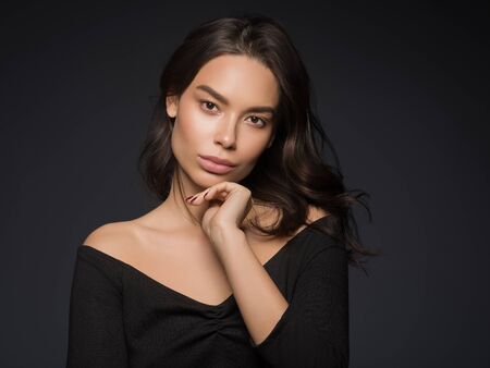 Asian beauty female black background curly black hair natural make up. Studio shot.の写真素材