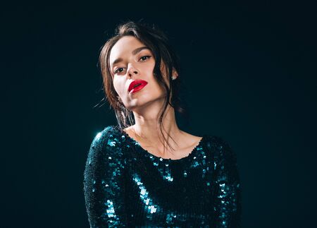 Woman in sequin dress night club concept red lips asian beauty. Studio shot.の写真素材