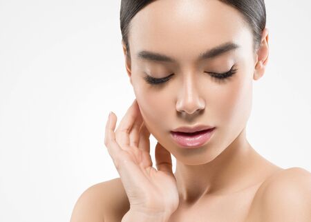 Asia beauty woman  with closed eyes healthy skin face clean fresh skin spa. Studio shot.  Isolated on white.の写真素材