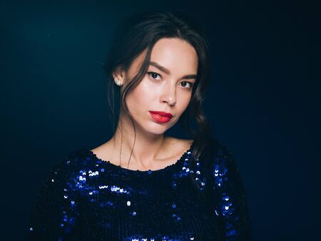 Woman in sequin dress night club concept red lips asian beauty. Studio shot.の写真素材