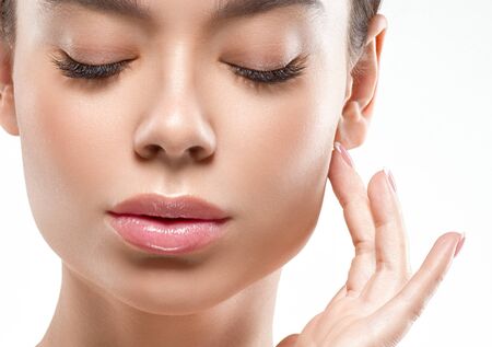 Asia beauty woman  with closed eyes healthy skin face clean fresh skin spa. Studio shot.  Isolated on white.の写真素材