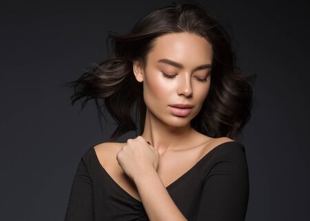 Asian beauty female black background curly black hair natural make up. Studio shot.の写真素材