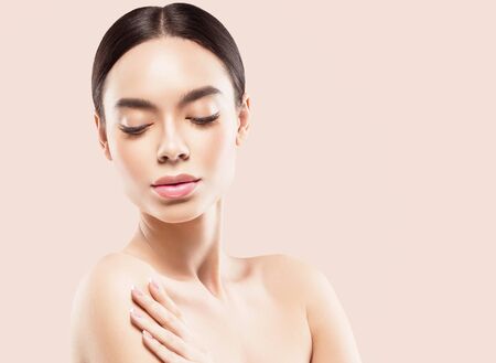 Asia beauty woman  with closed eyes healthy skin face clean fresh skin spa. Studio shot. Color background.の写真素材
